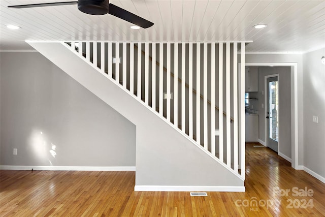 staircase featuring hardwood / wood-style floors and wooden ceiling