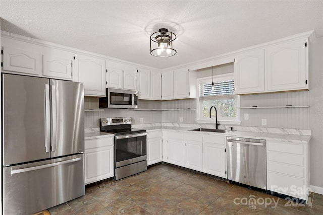 kitchen with white cabinetry, sink, and appliances with stainless steel finishes