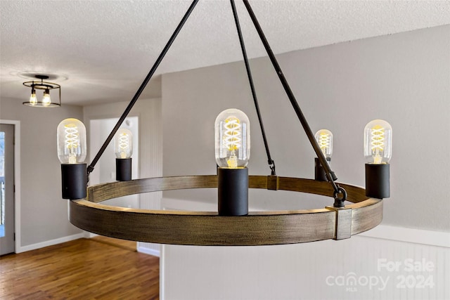 room details with wood-type flooring and a textured ceiling