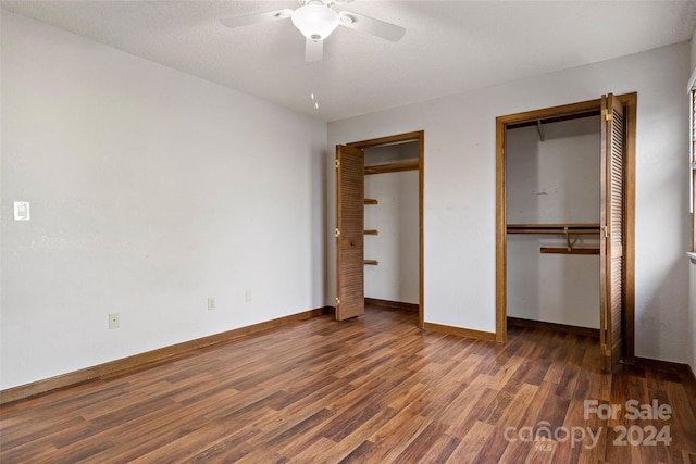 unfurnished bedroom with ceiling fan, dark hardwood / wood-style flooring, and a textured ceiling