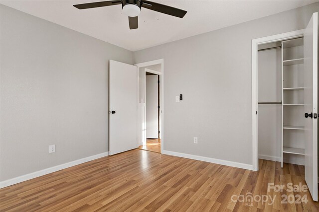 unfurnished bedroom featuring ceiling fan and light wood-type flooring