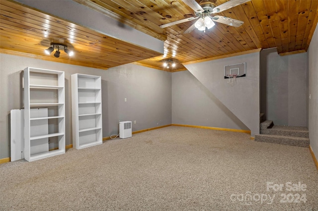 basement with ceiling fan, built in features, wooden ceiling, and carpet floors