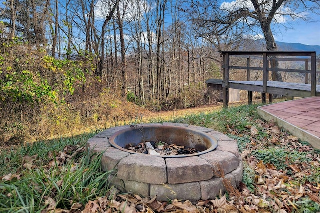 view of yard with a mountain view and a fire pit