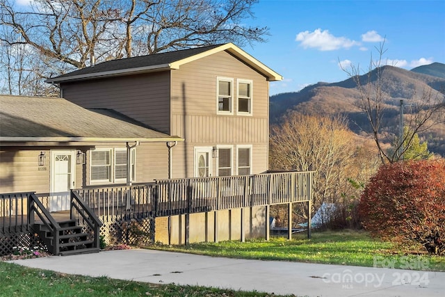 rear view of property with a deck with mountain view