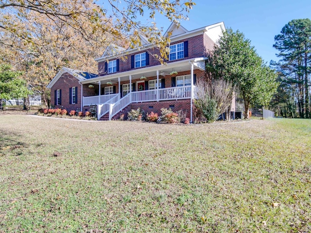 view of front of property with a porch and a front lawn