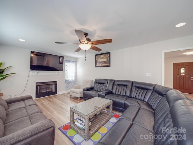 living room with wood-type flooring and ceiling fan