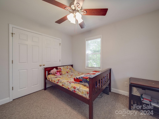 bedroom with a closet, light colored carpet, and ceiling fan