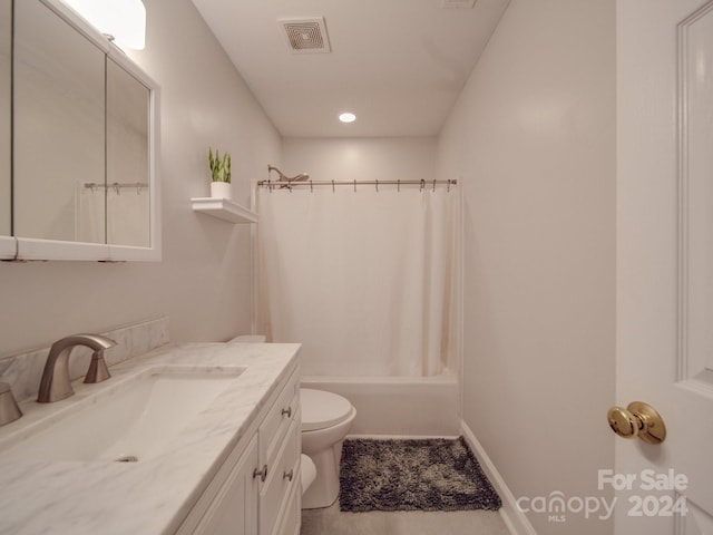 full bathroom with tile patterned flooring, shower / tub combo, vanity, and toilet