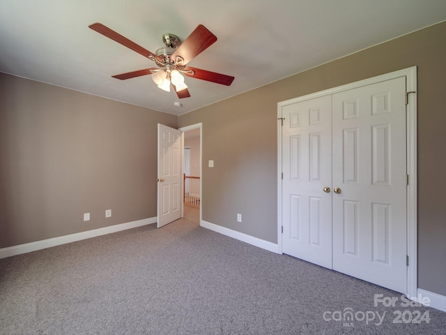 unfurnished bedroom with ceiling fan, a closet, and carpet floors