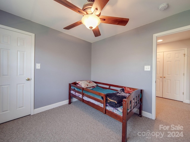 carpeted bedroom featuring ceiling fan