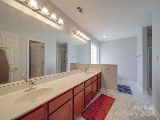 bathroom with vanity and a shower with door