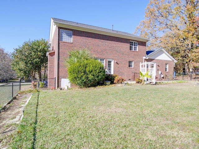 rear view of house with a yard