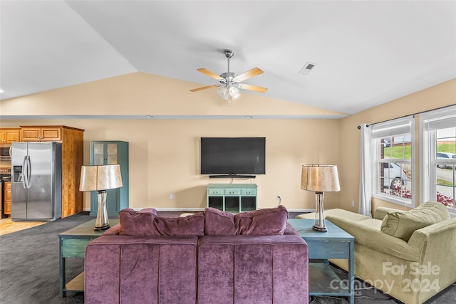 living room featuring dark colored carpet, vaulted ceiling, and ceiling fan