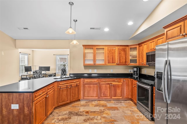 kitchen featuring kitchen peninsula, stainless steel appliances, sink, decorative light fixtures, and lofted ceiling