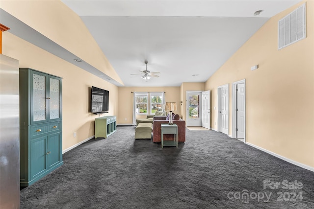 unfurnished dining area featuring ceiling fan, high vaulted ceiling, and dark carpet