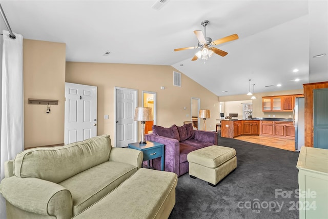 living room featuring dark colored carpet, ceiling fan, and lofted ceiling