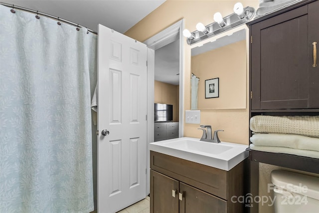 bathroom with tile patterned flooring and vanity