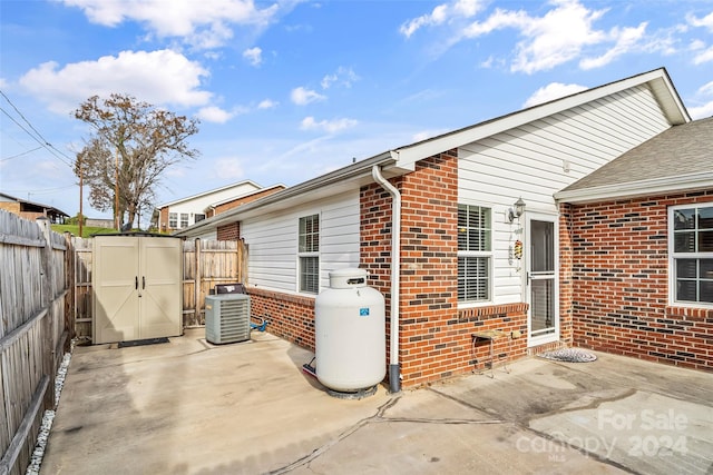 exterior space featuring a shed, central AC unit, and a patio area