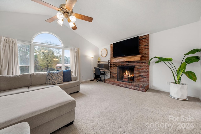 living room with a brick fireplace, light colored carpet, vaulted ceiling, and ceiling fan