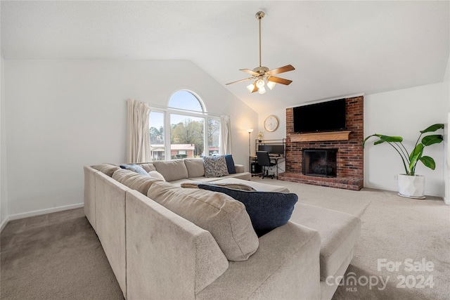 living room with ceiling fan, light colored carpet, a fireplace, and vaulted ceiling