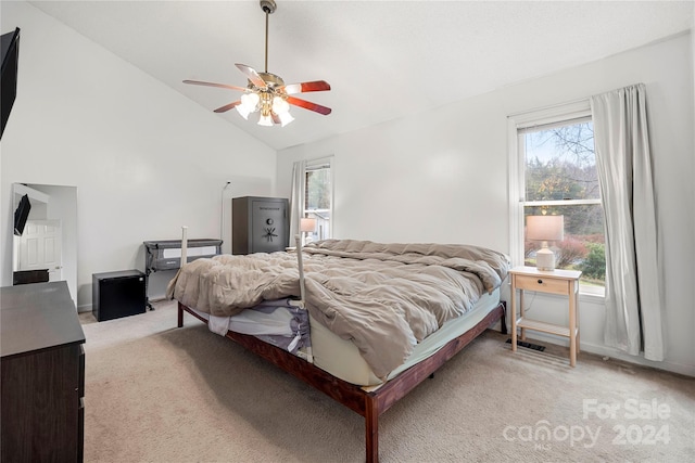 bedroom with multiple windows, light colored carpet, ceiling fan, and lofted ceiling