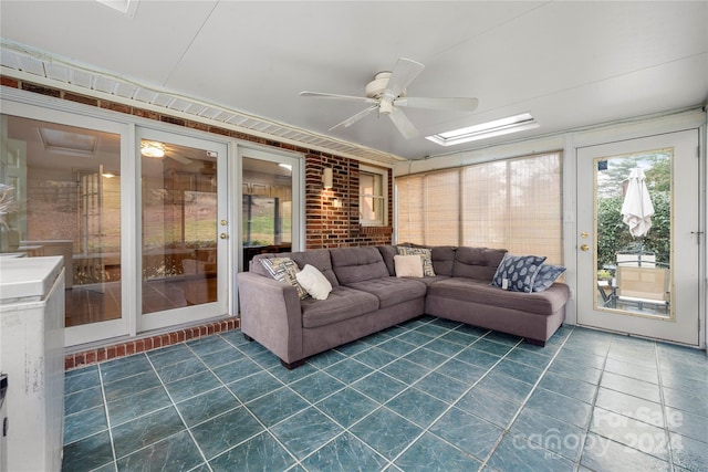 sunroom / solarium with ceiling fan and a skylight