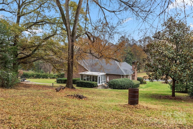 view of yard with a sunroom