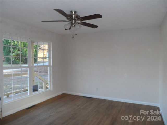 empty room featuring ceiling fan and dark hardwood / wood-style floors