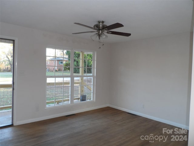 unfurnished room featuring ceiling fan and dark hardwood / wood-style flooring