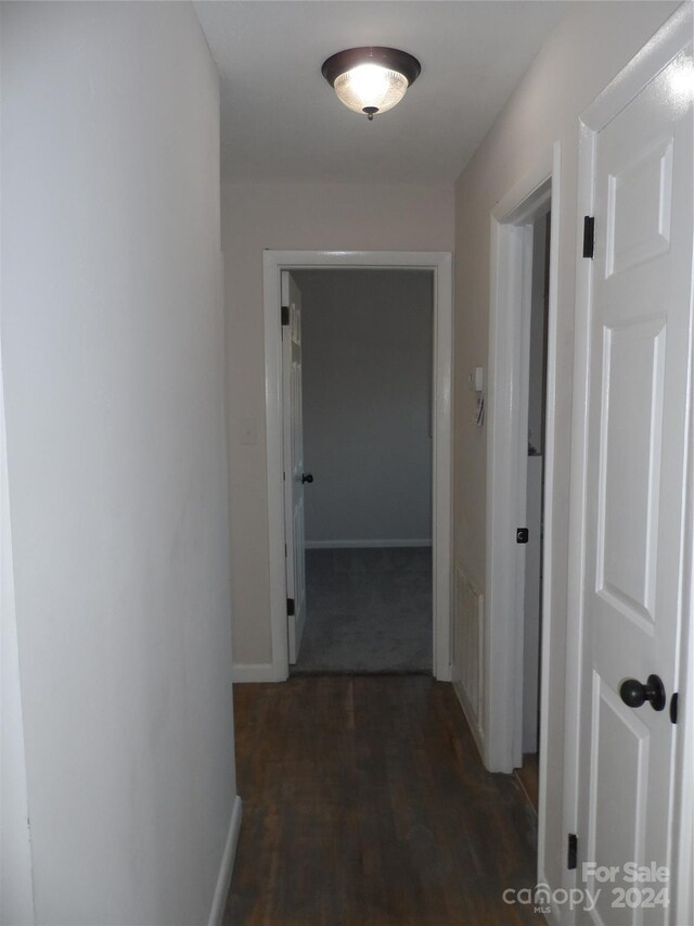 hall with dark hardwood / wood-style flooring