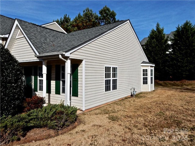 view of side of property with a lawn