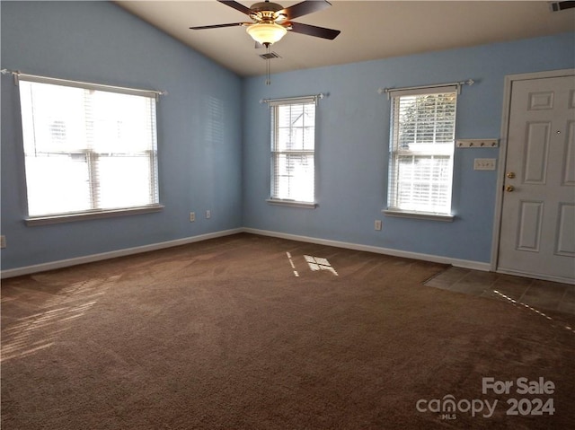 carpeted empty room with ceiling fan and lofted ceiling