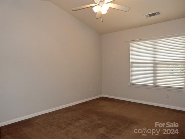 carpeted empty room featuring ceiling fan and vaulted ceiling