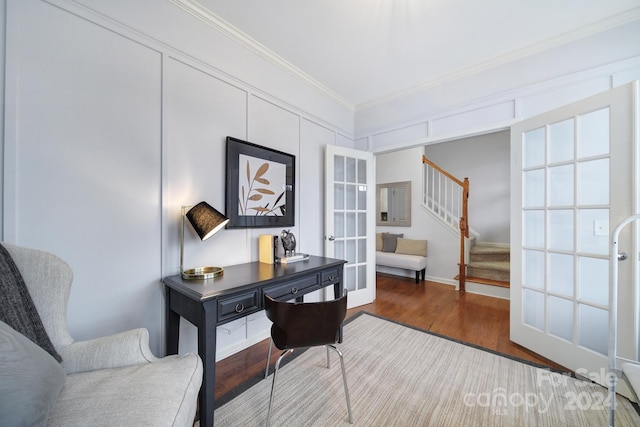 home office with dark hardwood / wood-style floors, ornamental molding, and french doors