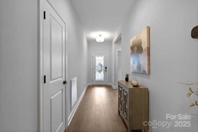 doorway with hardwood / wood-style floors