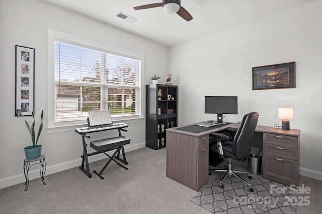 office space featuring light carpet and ceiling fan