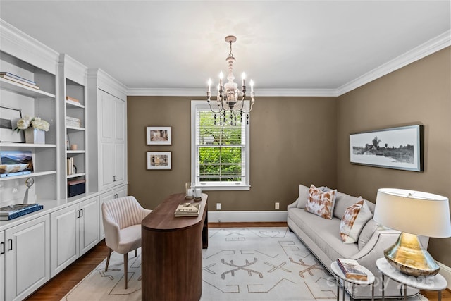 office area with a chandelier, light wood finished floors, ornamental molding, and baseboards