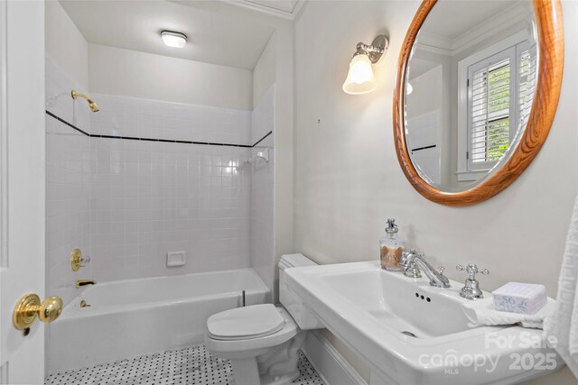 full bath with toilet, tub / shower combination, tile patterned flooring, and a sink