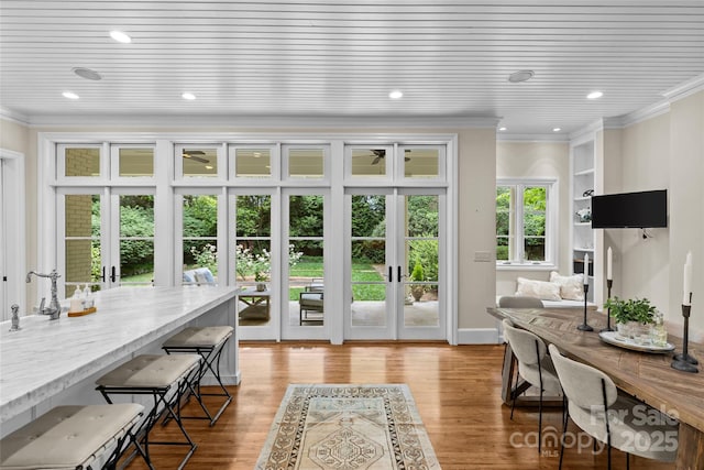 doorway featuring crown molding, french doors, light wood-style floors, recessed lighting, and baseboards