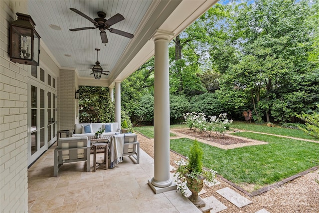 view of patio with an outdoor living space, ceiling fan, french doors, and view of scattered trees