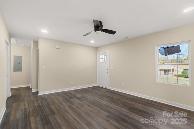 unfurnished room featuring electric panel, ceiling fan, and dark wood-type flooring