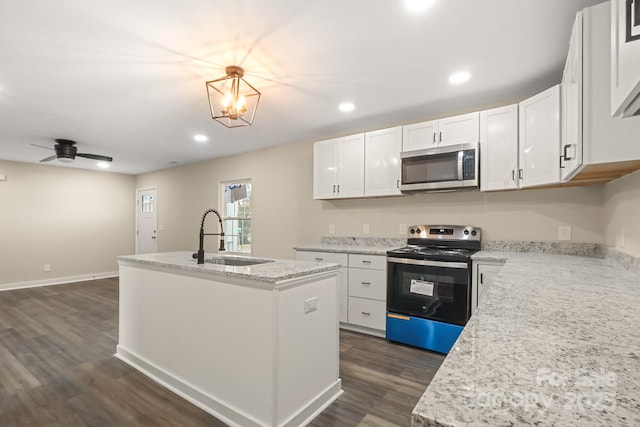 kitchen featuring white cabinetry, sink, a center island with sink, ceiling fan with notable chandelier, and appliances with stainless steel finishes