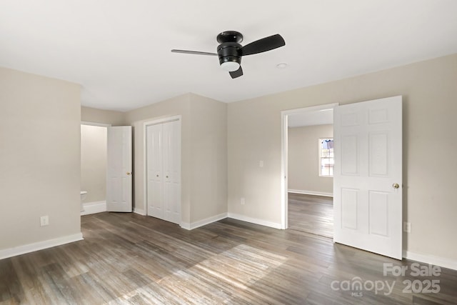 spare room with ceiling fan and dark wood-type flooring