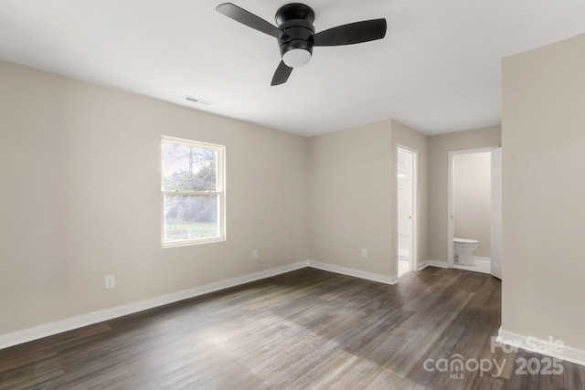 spare room with ceiling fan and dark wood-type flooring