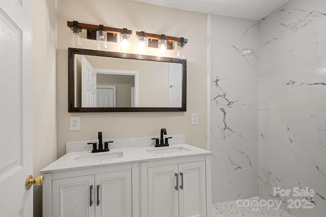 bathroom with vanity and tiled shower