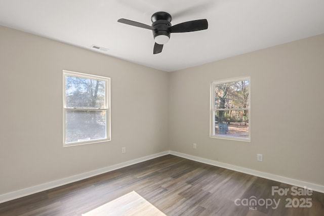 unfurnished room with ceiling fan and dark wood-type flooring