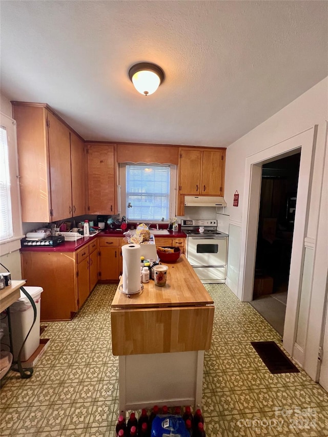 1716 3rd St NE, Hickory, NC 28601 - kitchen featuring electric range, a kitchen island, and a textured ceiling