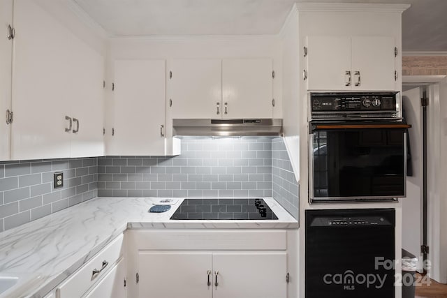 kitchen featuring decorative backsplash, crown molding, white cabinets, and black appliances