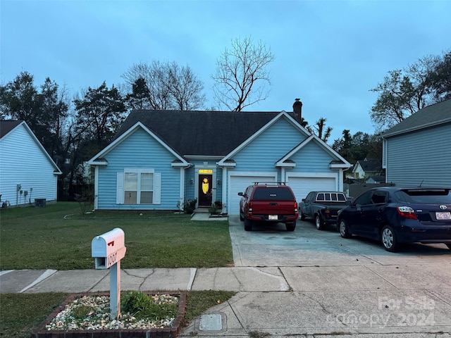 view of front of home with a front yard, central AC, and a garage