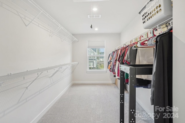 walk in closet with carpet